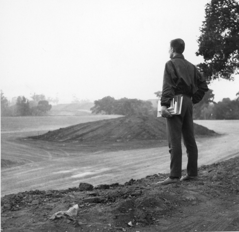 A Foothill College student watches from atop a hill as the campus begins to take shape.
