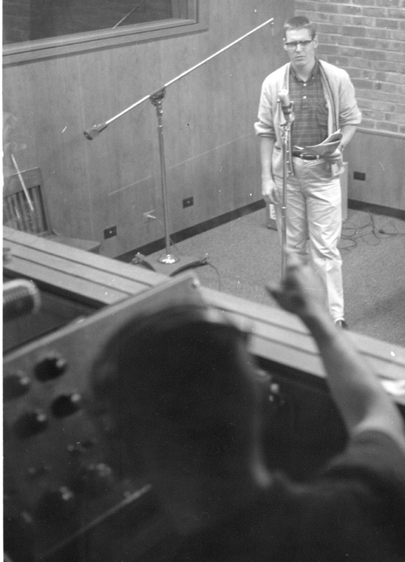 Bob Ballou at the microphone in the recording room with an unidentified student at the control booth in the basement of Foothill College in Mountain View. 