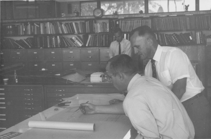 Calvin Flint, Foothill College's first President, later the first District Superintendent, reviews blue prints for the award winning design of Foothill College. 