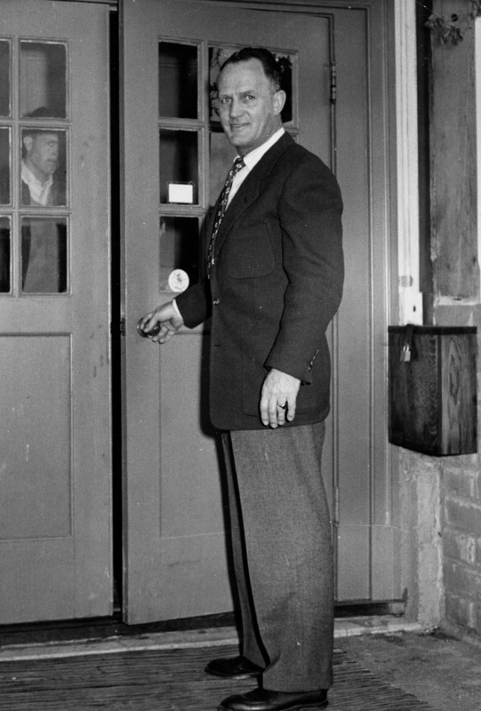 Calvin Flint stands at the rear entrance to the first meeting space for the Board of Trustees, located in a small building in downtown Los Altos. The Board continued to meet in this space from 1958 until 1961, when the new Foothill campus opened in Los Altos Hills.
