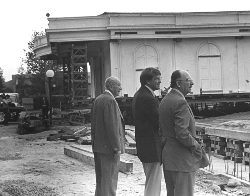 Three men observe the progress as Le Petite Trianon is being moved to a new location. On the right, closest to the camera, is Dr. Robert Smithwick, the District's first Board Chairperson. In the center is Dr. A. Robert DeHart, De Anza's first President. The man on the left has not been identified. Image taken in the late 1960s.
