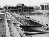 Construction of the two pools and large gymnasiums continues in late 1965. 