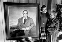 Calvin Flint's widow, Lenore Flint Maxwell (left) and Mary Ann Walburn view the oil portrait of Dr. Calvin C. Flint before it is mounted on a hallway wall inside the Flint Center for the Performing Arts in 1982.