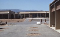 Students and community members explore the nearly completed campus. In this photo, the Library can been seen straight ahead, and the Administration building is on the right. Photographer unknown.