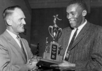 Dr. Calvin C. Flint presents the Most Valuable Athlete of 1960-1961 award to Mike Nichols, who excelled in football, basketball and baseball for Foothill College. Photo taken in 1961 at the temporary college location in Mountain View. 