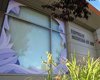 Spray-painted lavender crystalline shapes frame the Euphrat Museum front window.