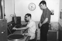 Two students working at the KFJC broadcast desk in the basement of Foothill College in Mountain View in a photo from 1960. 