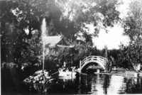 Willard M. Griffin takes his dog for a ride in his rowboat on the fish pond that surrounds an island upon which the tea house sits. Note the gushing water feature in the pond, not seen in other photos. Date of photo unknown, but estimated to be between 1906 and 1913.