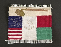 Small weaving. A brown hoe at the top, partial flags of the U.S. and Mexico below.