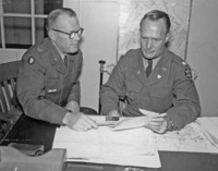 
Lt. Col. Calvin Flint (right) reviews papers during his reserve duty at Ford Ord in Monterey California in the 1950s.

