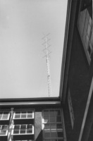 Photograph of installed KFJC radio antenna on the roof of Foothill College building in Mountain View in 1959. Upper floor of the building is visible. 