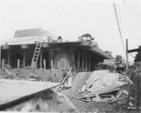 A construction crew works on the roof  of one of the original classroom buildings at Foothill.