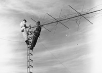 Two engineers finish rewiring the KFJC radio antenna on Black Mountain in this photograph from the October 12, 1962 issue of the Foothill Sentinel. Photograph by Jeanette Huston. 