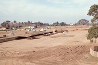 The land has been cleared and construction has just begun on the De Anza College campus. The Baldwin Winery building can be seen just left of the center of the image.