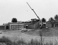 A large crane stands idle as construction continues in late 1965.