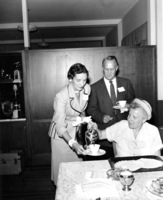 Calvin C. Flint and his wife, Lenore Flint, are served coffee. Photo taken in early 1960s. Location unknown. 