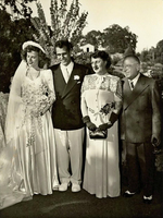 Wedding photo of the young couple with his parents.
