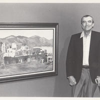 Artist standing next to his painting.