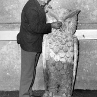 Calvin Flint pretends to "tweek" the nose of Footsie, the owl that is Foothill's mascot. The stone owl came from Foothill's temporary location in Mountain View, where this picture was taken in 1959. The owl was moved to the campus in Los Altos Hills in 1961, where it remains to this day,  mounted on a wall inside the main dining room.
