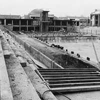 Construction of the two pools and large gymnasiums continues in late 1965. 