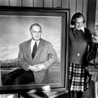 Calvin Flint's widow, Lenore Flint Maxwell (left) and Mary Ann Walburn view the oil portrait of Dr. Calvin C. Flint before it is mounted on a hallway wall inside the Flint Center for the Performing Arts in 1982.