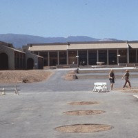 Students and community members explore the nearly completed campus. In this photo, the Library can been seen straight ahead, and the Administration building is on the right. Photographer unknown.