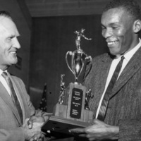Dr. Calvin C. Flint presents the Most Valuable Athlete of 1960-1961 award to Mike Nichols, who excelled in football, basketball and baseball for Foothill College. Photo taken in 1961 at the temporary college location in Mountain View. 