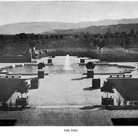 The Baldwins, who owned Le Petite Trianon in the early 1900s, had the first private swimming pool in Cupertino. This view is taken from the steps of the Pavilion,  now known as The California History Center. Just behind the curved section of concrete fence is the current location of the Learning Center at De Anza College.  