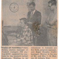 Photograph of Bob Ballou at the KFJC broadcast desk with program manager Roy Ruth and traffic manager Roger Murray standing behind him.