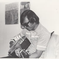 Musician playing guitar.