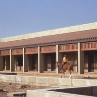 A local resident rides her horse through the L Quad area as De Anza College is being built. When this photo was taken (1966 or 1967) the area surrounding the college was mostly agricultural. Photo by Pat Bresnan, faculty, De Anza College.