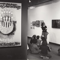 Includes 10th anniversary poster with paintbrushes as candles on a cake.