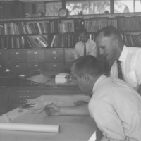 Calvin Flint, Foothill College's first President, later the first District Superintendent, reviews blue prints for the award winning design of Foothill College. 