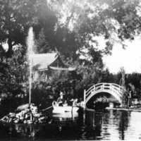 Willard M. Griffin takes his dog for a ride in his rowboat on the fish pond that surrounds an island upon which the tea house sits. Note the gushing water feature in the pond, not seen in other photos. Date of photo unknown, but estimated to be between 1906 and 1913.