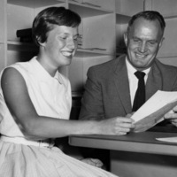 Sherill Ann Houseman, who plans to enroll at Foothill College, talks with Dr. Calvin C. Flint about her plans as a psychology major. Photo taken in 1958 at Foothill College's temporary location in Mountain View.