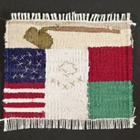 Small weaving. A brown hoe at the top, partial flags of the U.S. and Mexico below.