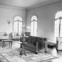 The interior of Le Petit Trianon includes this sitting room with windowed doors that open onto patios on three sides. Photo taken in 1959. Photographer unknown.
