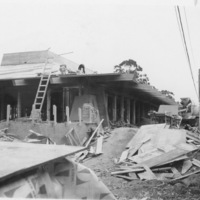 A construction crew works on the roof  of one of the original classroom buildings at Foothill.