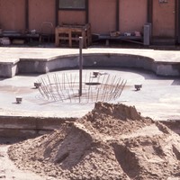 The large fountain, located in the center of campus near the Administration building, has quite a bit of work remaining before campus opens in Fall of 1967. 