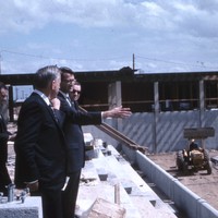 A. Robert DeHart, President Elect, De Anza College (center, hand extended) gives a campus tour to show construction progress of the anxiously awaited new college. 