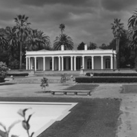 Le Petite Trianon is shown here in its original location on the land that would later become De Anza College. The rear of the building faces Stevens Creek Blvd., in a location that would  be occupied by the Flint Center for the Performing Arts. The Flint Center opened in 1971 and is scheduled for demolition in 2022. The swimming pool in the foreground later become a fountain in the Sunken Garden at De Anza.