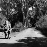 A second view of Calvin Flint  in a classroom desk on the site of the future Foothill College. This photo was taken in 1958, just after the purchase of 122 acres of land in Los Altos Hills was completed for approximately $900,000. The purchase was funded by a local bond.