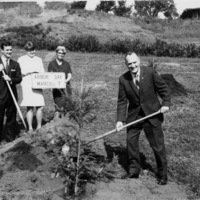 Dr. Calvin C. Flint helps to plant a tree at Foothill for Arbor Day 1962. Dr. Flint himself had said that he enjoyed "swinging a shovel" and working with plants at his home. 