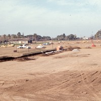 The land has been cleared and construction has just begun on the De Anza College campus. The Baldwin Winery building can be seen just left of the center of the image.