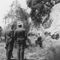 Foothill College architects study plans for the new college while standing near the giant rocks that are still at the entrance to the college.