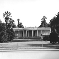 Le Petite Trianon is now surrounded by a fence to protect it from intruders. The home would soon be raised and moved to a new location where it would be restored and renamed The California History Center.