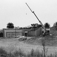 A large crane stands idle as construction continues in late 1965.