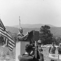 At the Foothill College ground breaking ceremony on June 30, 1960, Dr. Calvin C. Flint unveils a plaque commemorating the event. This plaque can still be viewed on the campus - it is affixed to the base of the flagpole near the Foothill Administration building. The campus opened to the public in September of 1961, just fifteen months after this ground breaking ceremony.