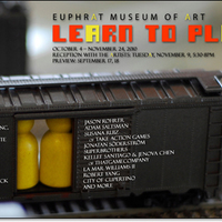 Toy train boxcar with game pieces inside. Basic show info.