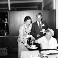 Calvin C. Flint and his wife, Lenore Flint, are served coffee. Photo taken in early 1960s. Location unknown. 